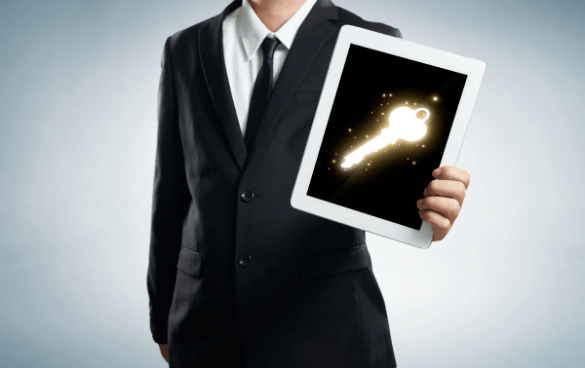 businessperson holding tablet with key