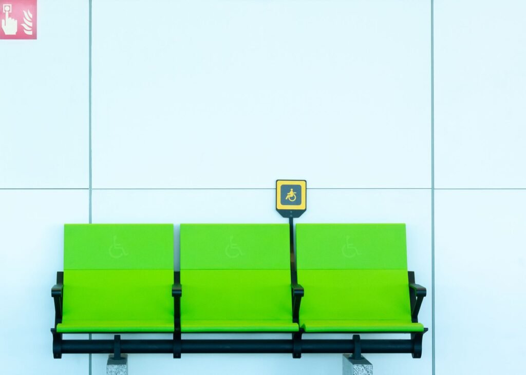 Vibrant green seats with handicap signs against a minimalist background.