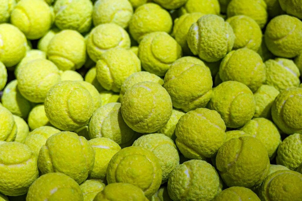 Close-up view of a large pile of bright yellow tennis balls.