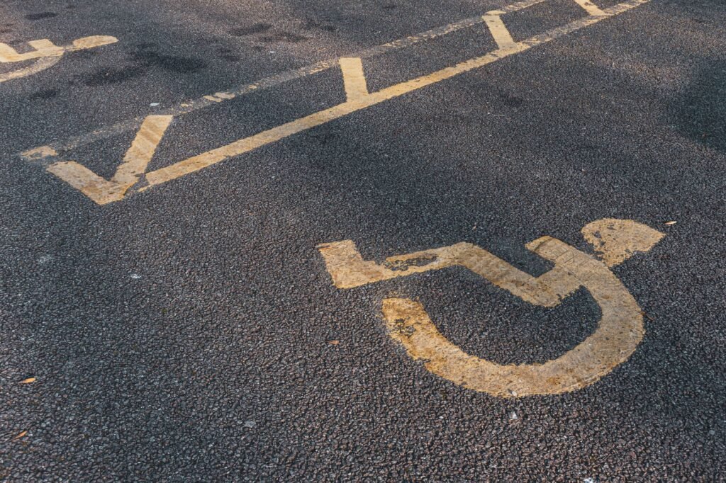 Prominent international wheelchair symbol on asphalt, illustrating accessibility.