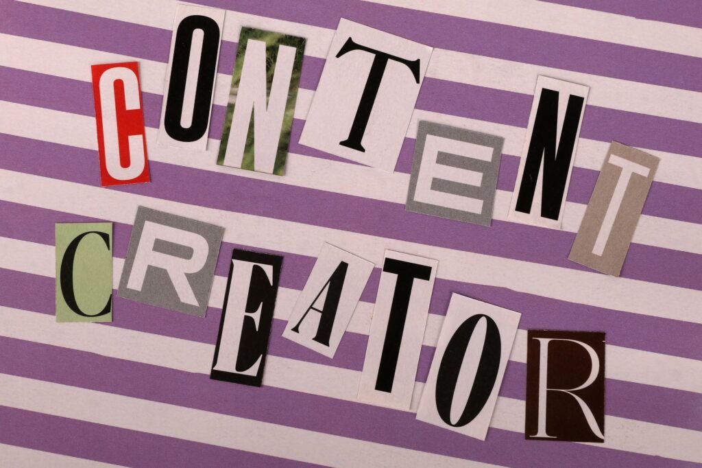 Artistic arrangement of 'Content Creator' text in a collage style on striped background.