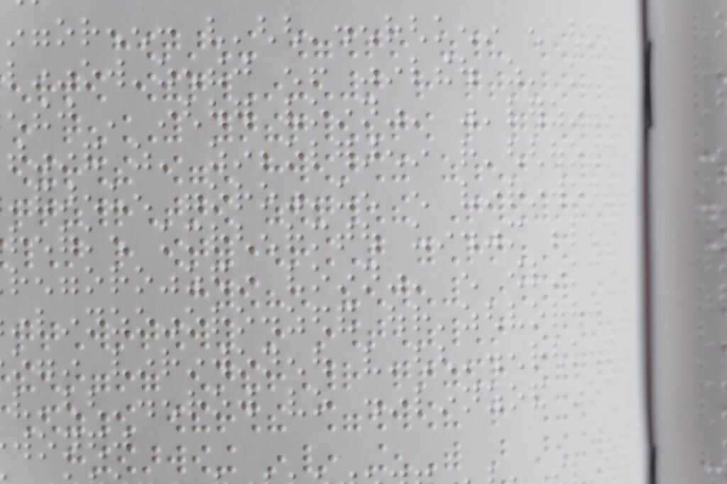 Detailed close-up of embossed Braille text, ideal for diversity and accessibility topics.