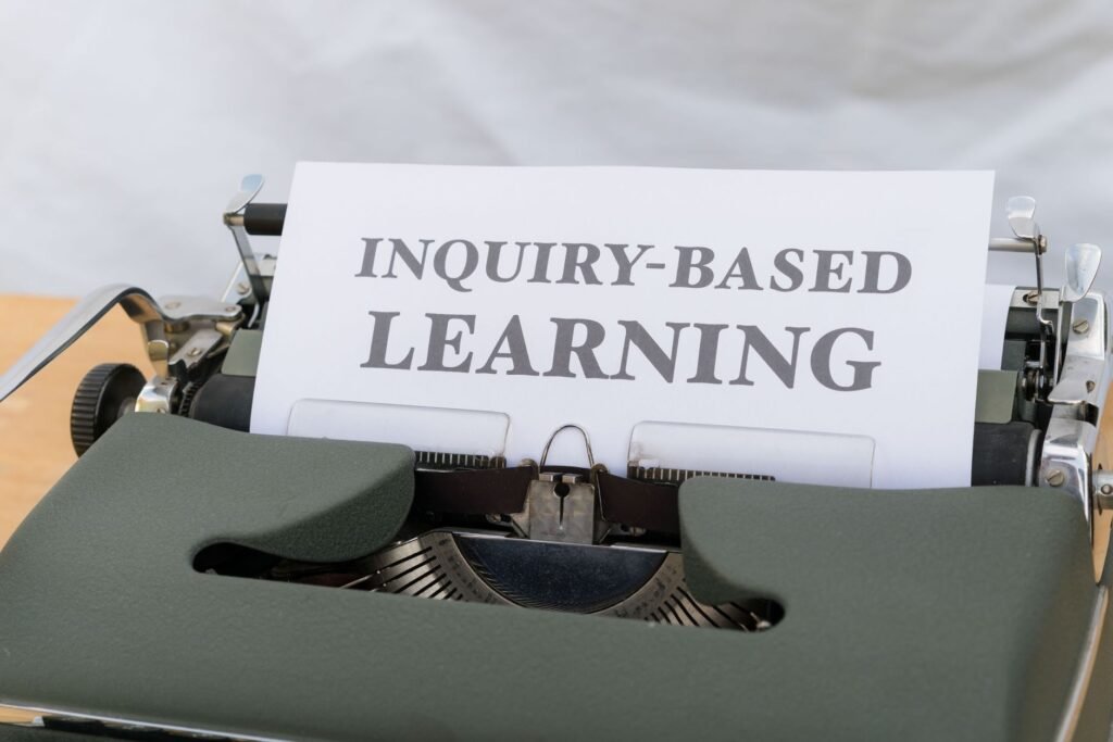 Vintage typewriter displaying 'Inquiry-Based Learning.'